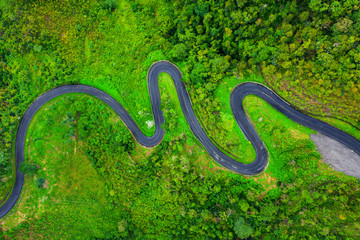 Aerial view of Beautiful sky road over top of mountains with green jungle in Nan province, Thailand.
