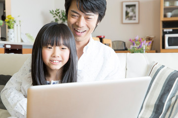 ノートパソコンを見る親子
