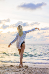Woman in swiming suit posing on the beach