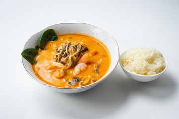 Traditional Asian soup with chicken or pig meat with udon noodles in a white bowl, isolate.