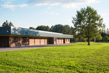Fototapeta na wymiar School building and schoolyard with field