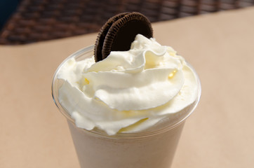 white milkshake with ice cream garnished with cookies