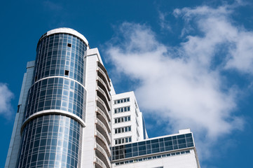 Russia, Khabarovsk,  July 14, 2020: High-rise modern office building against a blue sky with clouds
