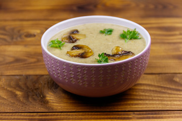 Mushroom cream soup on a wooden table