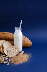 Slices of oat bran and bran bread lie on a blue background. Copy space