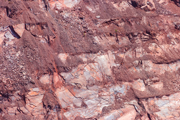 Close-up of red mining levels at iron ore quarry. Open-cast mine, open pit. Background, texture