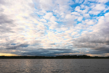 Fototapeta na wymiar Blue sky with dark clouds over a lake in the Smolensk region, Russia