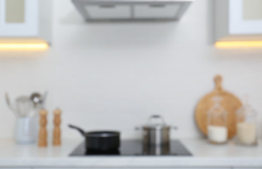 Fototapeta na wymiar Blurred view of modern kitchen with stove