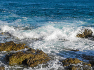 waves hitting rocks in the summer sun in Budva, Montenegro