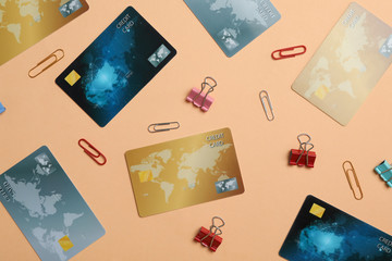 Flat lay composition with different credit cards and paper clips on beige background