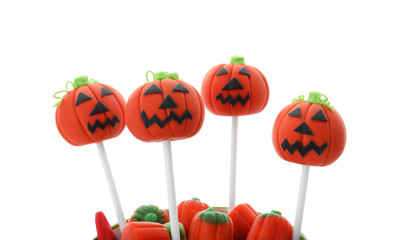 Delicious jack-o-lantern cake pops on white background. Halloween season