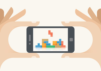 Gamer hands holding mobile smartphone with video game on screen. Concepts: Cybersport, championships, online gaming industry, old arcade games (Tetris etc.)