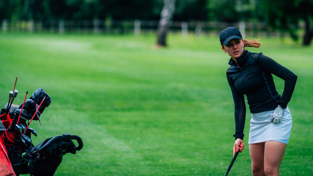 Young female golfer preparing to take a shot