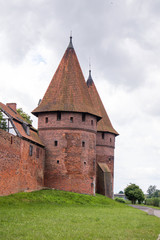 Fototapeta na wymiar Outside of Malbork Castle seen from Nogat river bank boulevard.