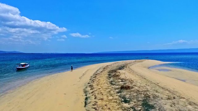 Indonesia travel Golden sandy beaches and blue skies of Dangar Ode Island. Aerial drone view.