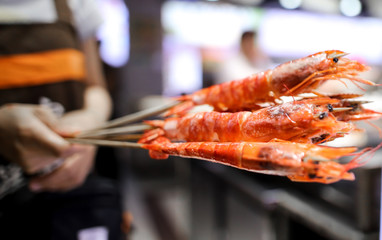 Shrimps on wooden sticks for grilling.