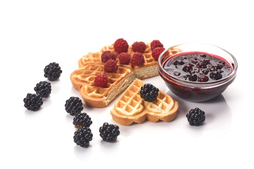 Belgium waffles with fresh berries and jam isolated on white background