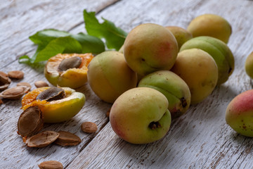 Naklejka na ściany i meble Apricot fruit. Fresh organic apricots on a white wooden background. Vega food.