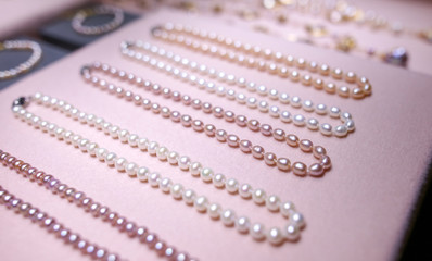 Pearl beads on a pink counter