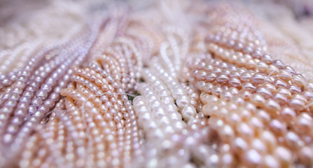 Pearl beads on a pink counter