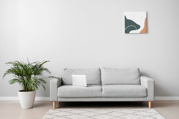 Interior of room with sofa and laptop