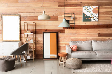 Stylish interior of living room with sofa and mirrors