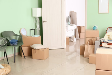 Cardboard boxes with belongings in new flat on moving day
