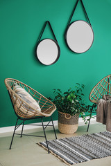 Interior of modern room with mirrors and armchairs