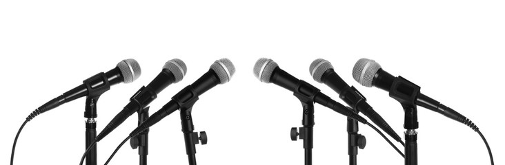Set of different microphones on white background