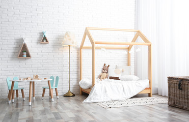 Cute children's room interior with bed and little table