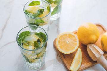 Glasses of fresh lemonade on table