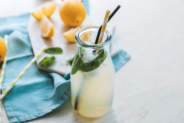 Bottle of fresh lemonade on table