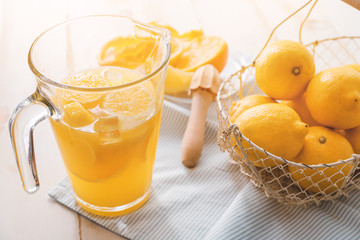 Jug of fresh lemonade on table
