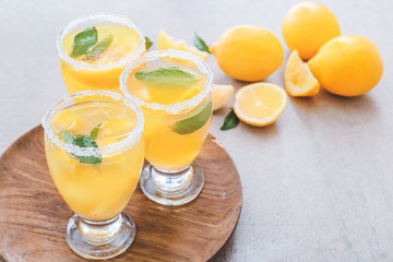 Glasses of fresh lemonade on table