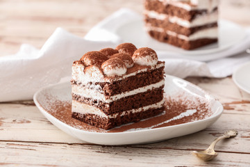 Plate with tasty tiramisu on table