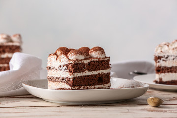 Plate with tasty tiramisu on table