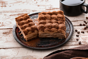 Plate with tasty tiramisu on table