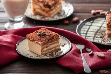 Plate with tasty tiramisu on table