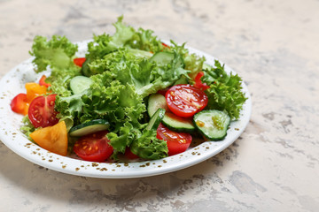 Plate with tasty cucumber salad on grey background