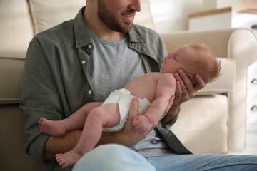 Obraz na płótnie Canvas Father with his newborn son at home, closeup