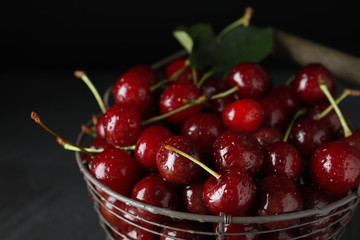 Sweet juicy cherries with water drops on dark background, closeup