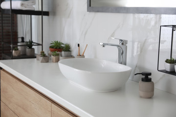 Fototapeta na wymiar Stylish vessel sink on bathroom counter. Interior design