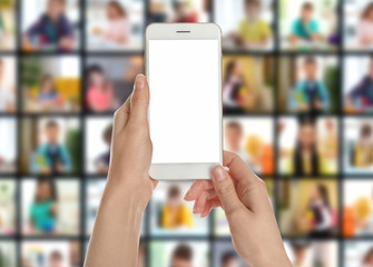 Distance education. Teacher using phone for online lesson during quarantine and lockdown due coronavirus pandemic, closeup