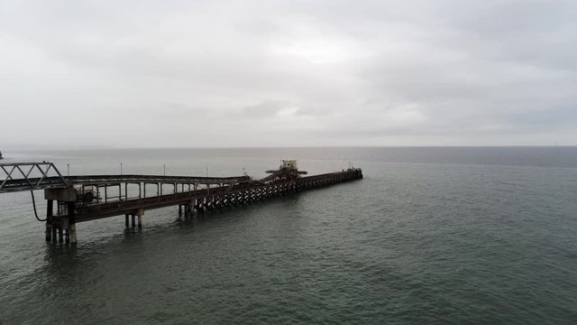 Aerial view Raynes jetty coastal quarry mining marine cargo landmark North Wales wide orbit right