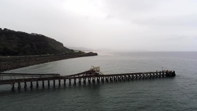 Aerial view Raynes jetty coastal quarry mining marine cargo landmark North Wales rising orbit right