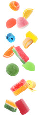 Different delicious candies falling on white background
