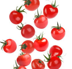 Many whole tomatoes falling on white background