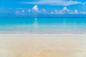 tropical beach with blue sky and clouds