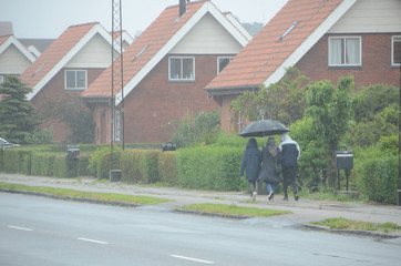 People on their way in strong rain.