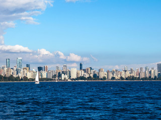 Sailboat and Vancouver skyline seen from the sea on a beautiful summer day.